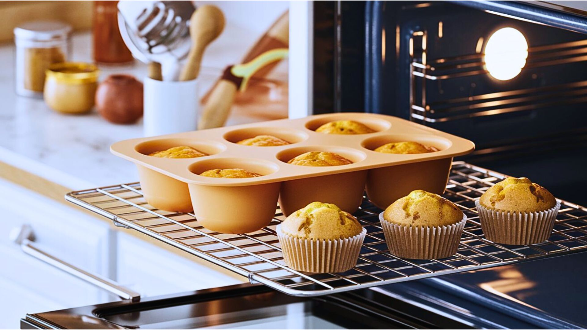 a silicone baking tray filled with batter, placed on an oven rack